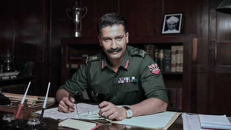 vicky kaushal in uniform sitting in office