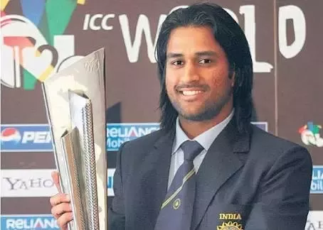 ms dhoni holding a trophy
