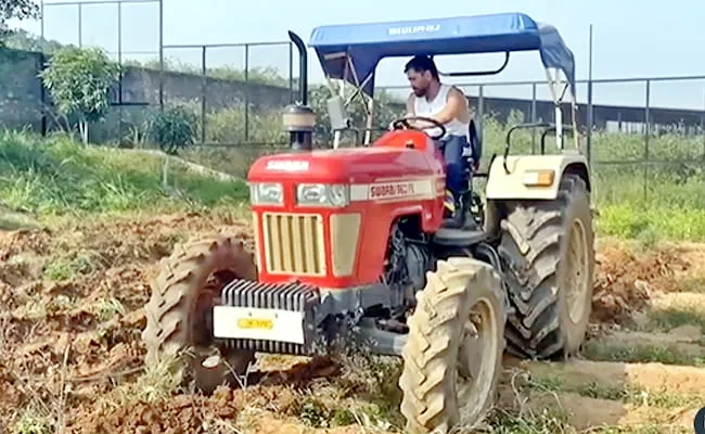 ms dhoni on his tractor