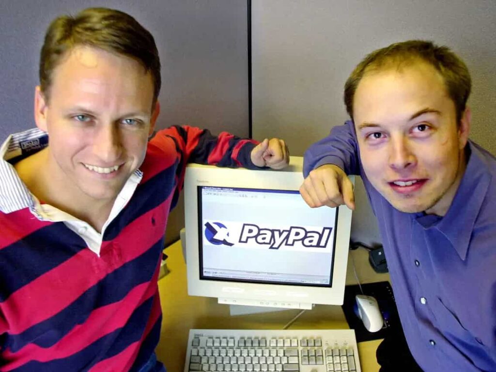 elon musk with his friend and computer screen reading 'paypal'